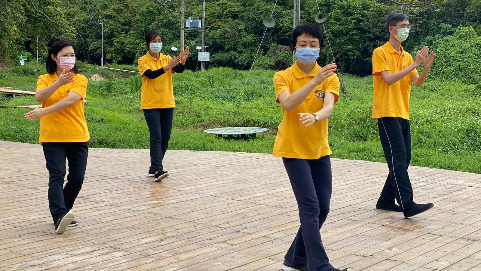 Rev. Dominic Chan practises Tai Chi Spirituality with assistants